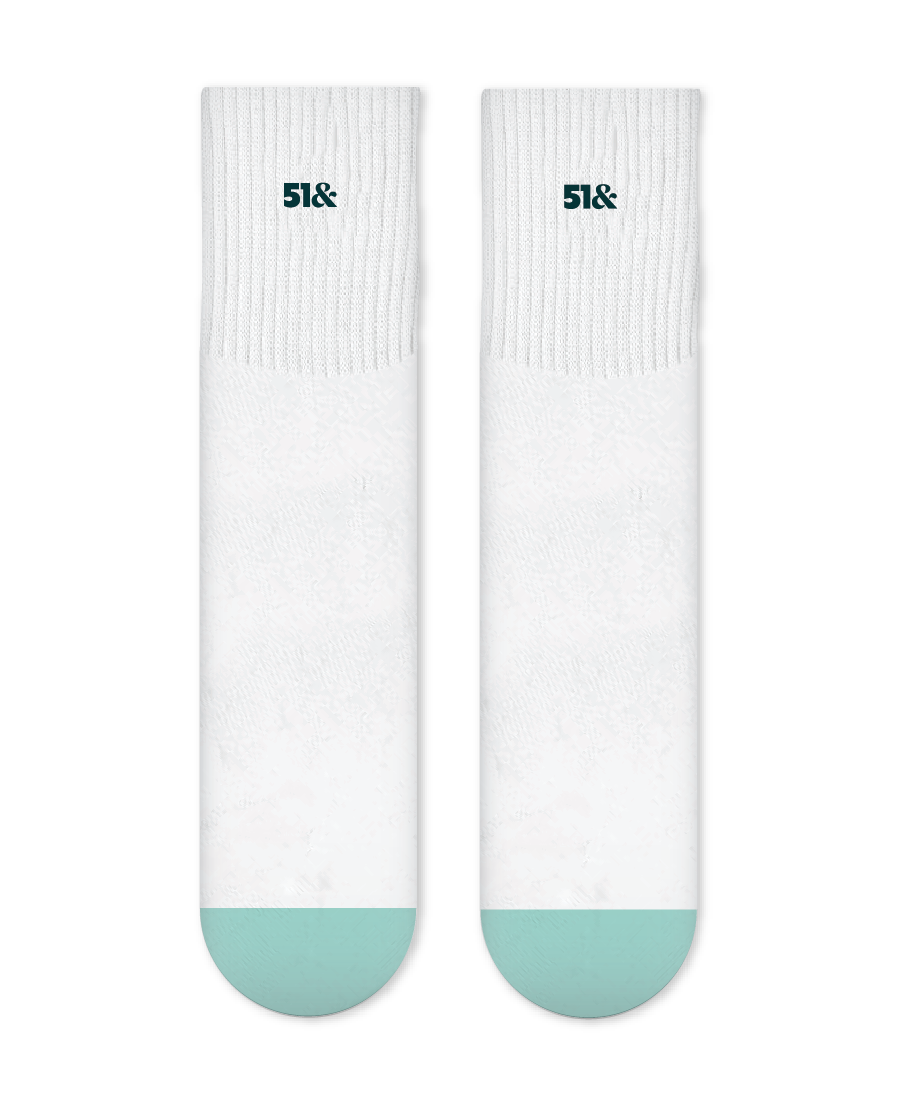 White socks with teal toes and heels on a white background